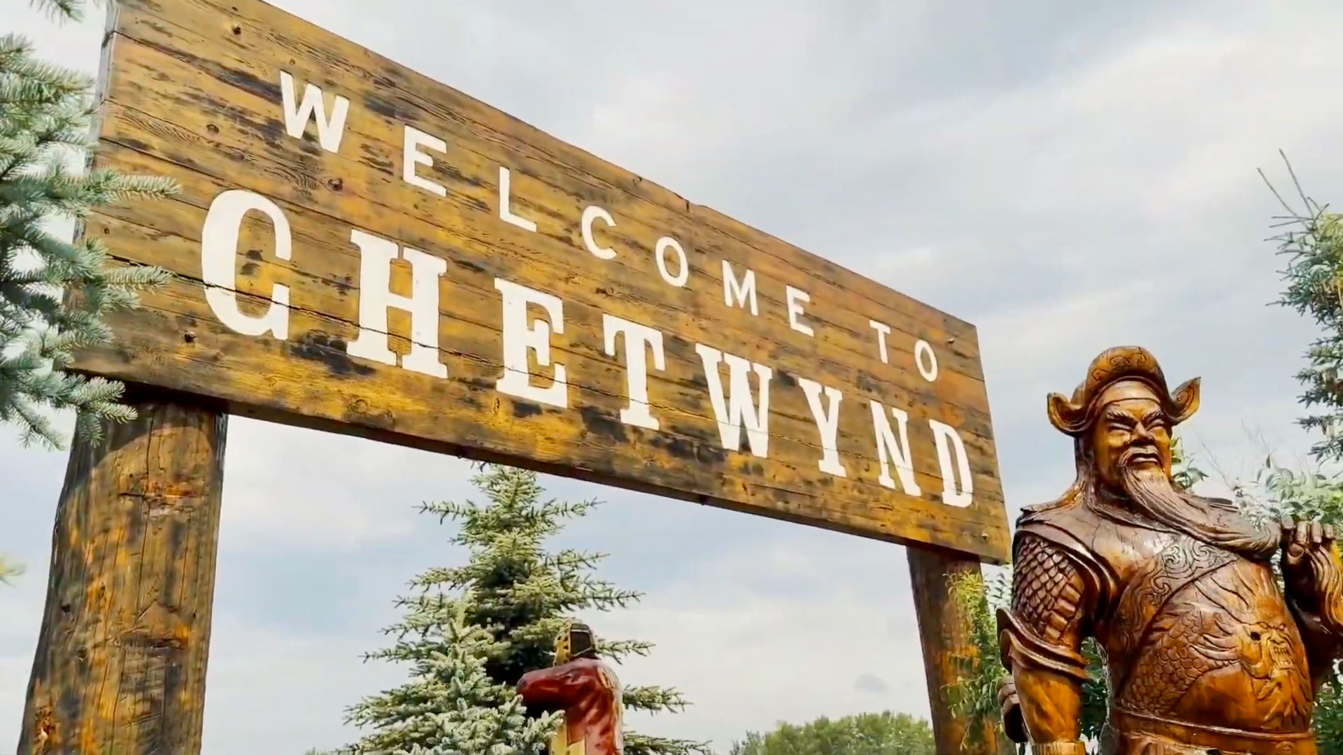 Chainsaw sculpture and a rustic carved Welcome to Chetwynd sign